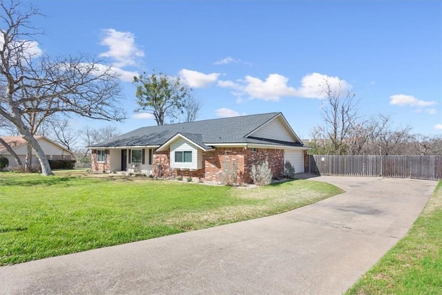 single story home with brick siding, a front lawn, fence, a garage, and driveway