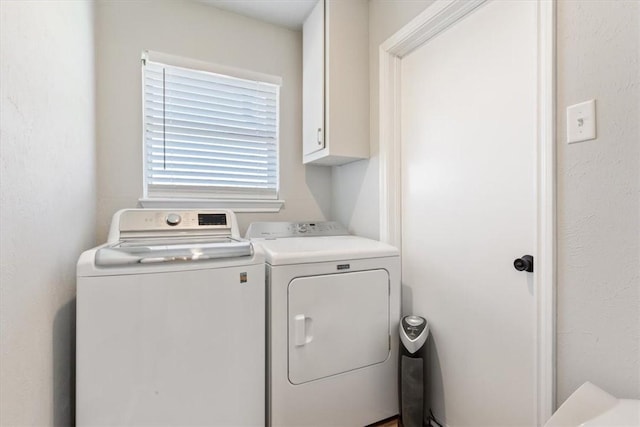 laundry area featuring cabinet space and separate washer and dryer