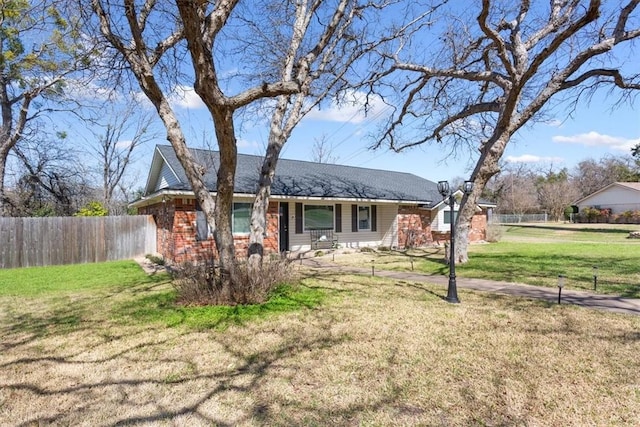 single story home with brick siding, a front lawn, and fence