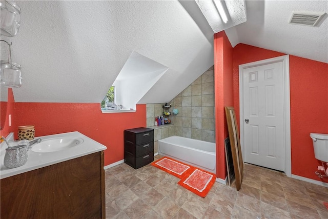 full bathroom featuring vanity, lofted ceiling, shower / bath combination with curtain, toilet, and a textured ceiling