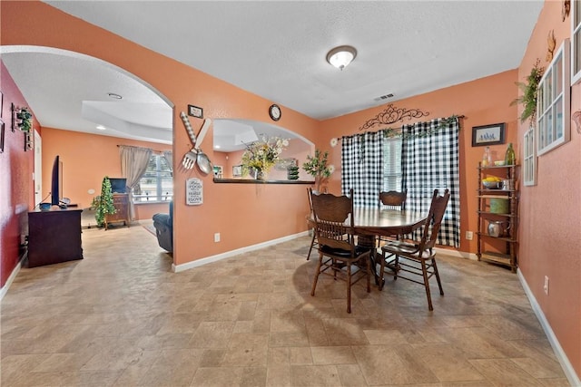 dining space featuring a textured ceiling