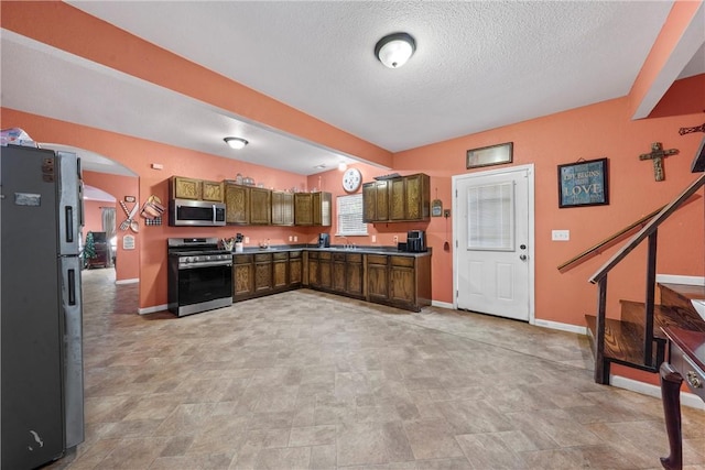 kitchen featuring sink, a textured ceiling, and appliances with stainless steel finishes