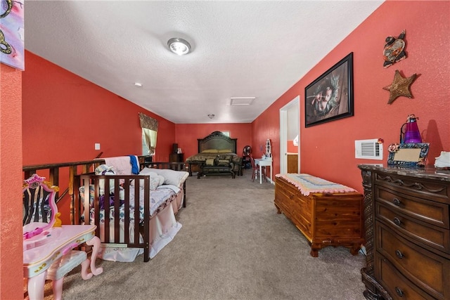 bedroom with a textured ceiling and light colored carpet