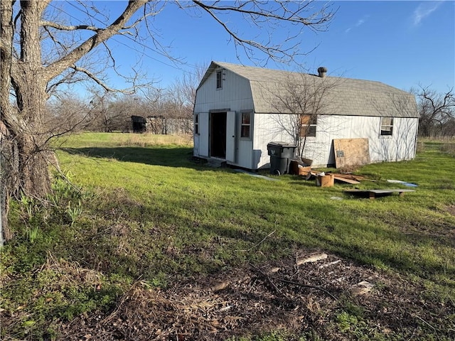 view of barn with a lawn