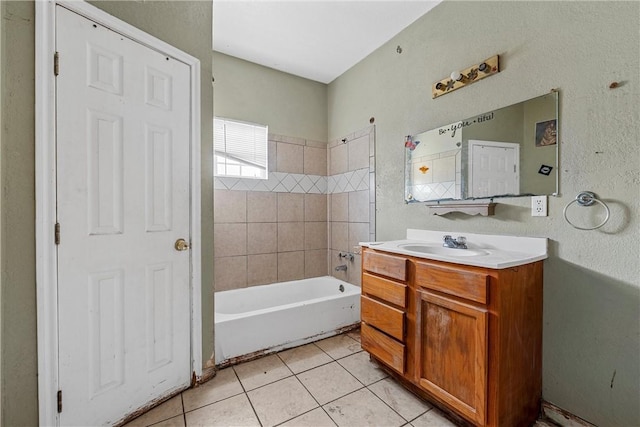 bathroom with tile patterned flooring, vanity, and tiled shower / bath combo