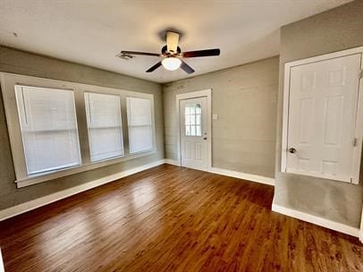 interior space with dark wood-type flooring and ceiling fan