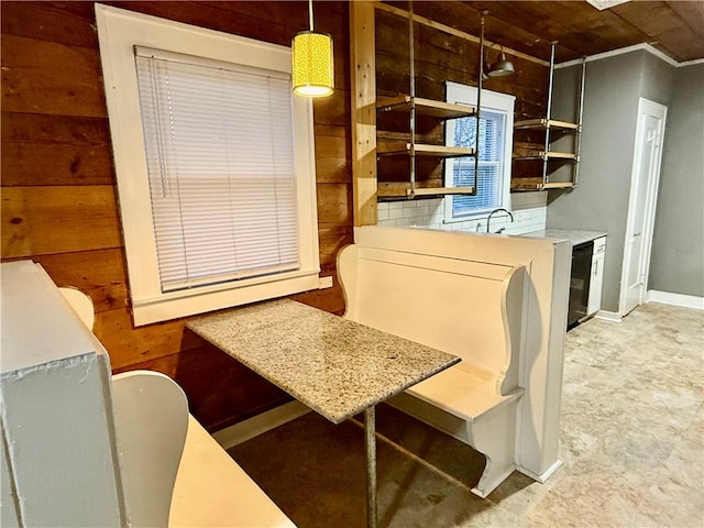 kitchen with wooden walls and decorative light fixtures