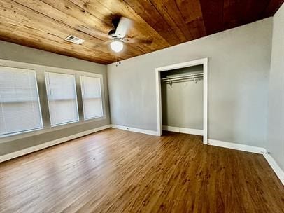 unfurnished bedroom with hardwood / wood-style flooring, ceiling fan, wood ceiling, and a closet