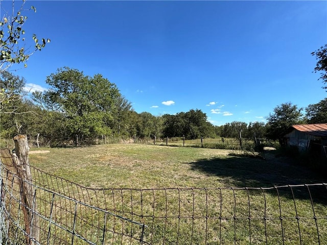 view of yard with a rural view