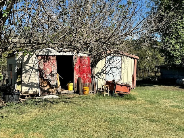 view of outbuilding featuring a yard