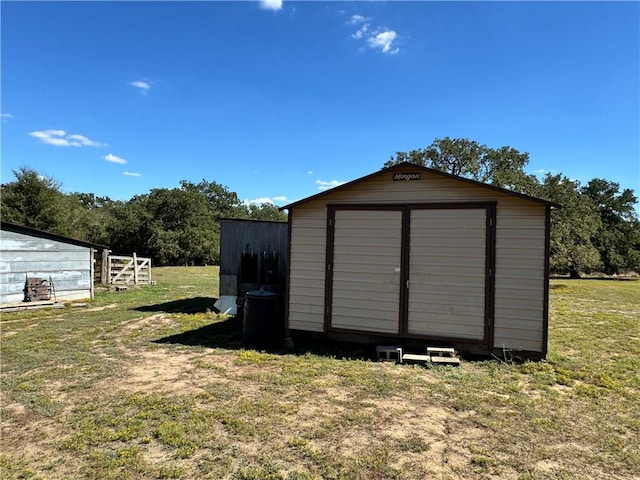 view of outbuilding featuring a lawn