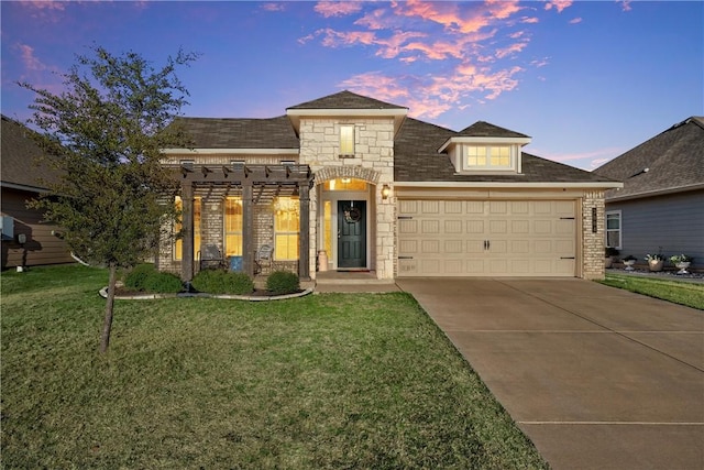 view of front of home with a garage and a lawn