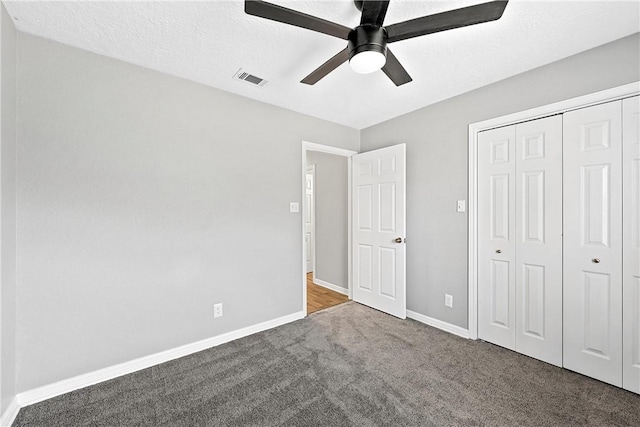 unfurnished bedroom with carpet floors, a closet, and ceiling fan