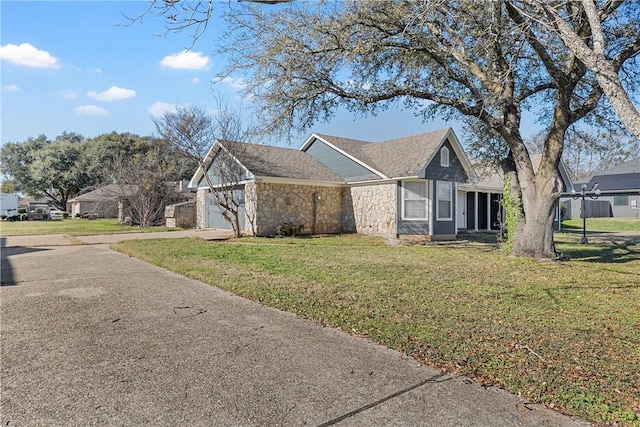 view of side of home with a lawn and a garage