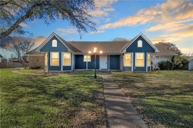 ranch-style house featuring a lawn