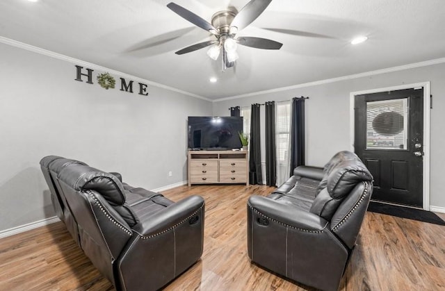 living room featuring ceiling fan, wood-type flooring, and ornamental molding