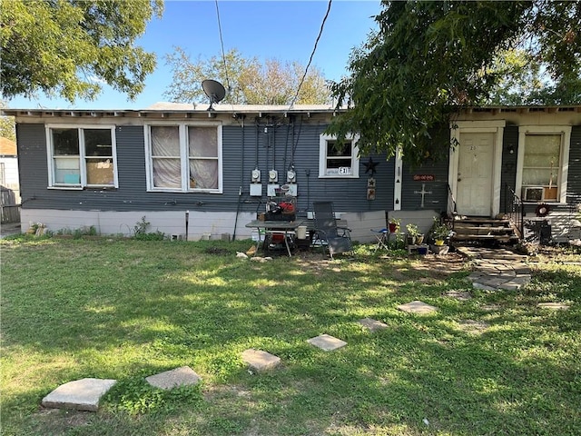 rear view of property with a lawn