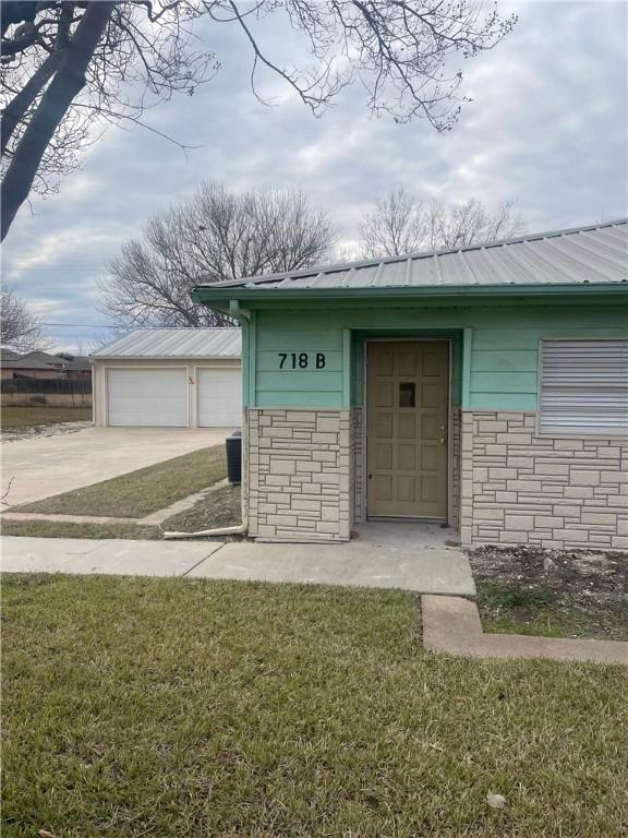 doorway to property featuring a yard