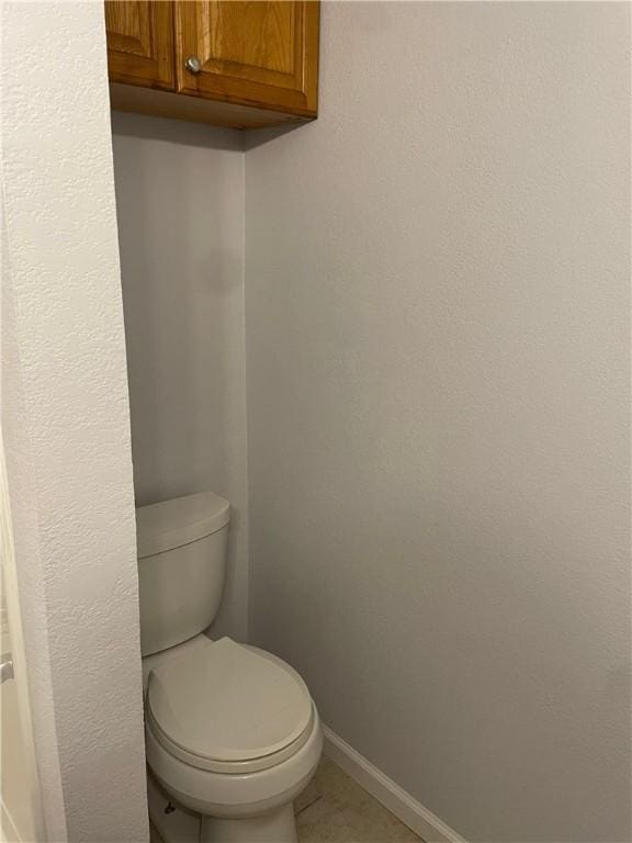 bathroom featuring toilet and tile patterned floors