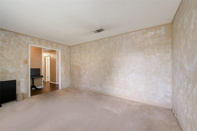 empty room featuring a textured ceiling