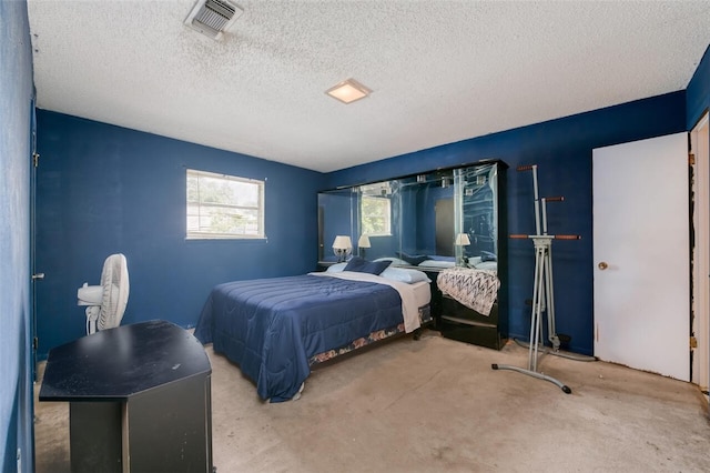 bedroom featuring light colored carpet and a textured ceiling