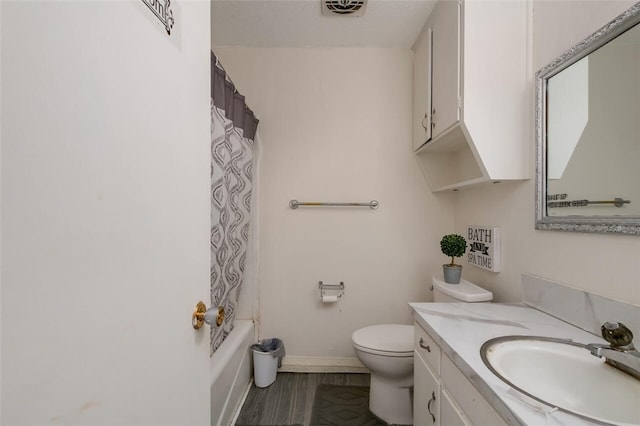 full bathroom featuring shower / bath combo, vanity, and toilet