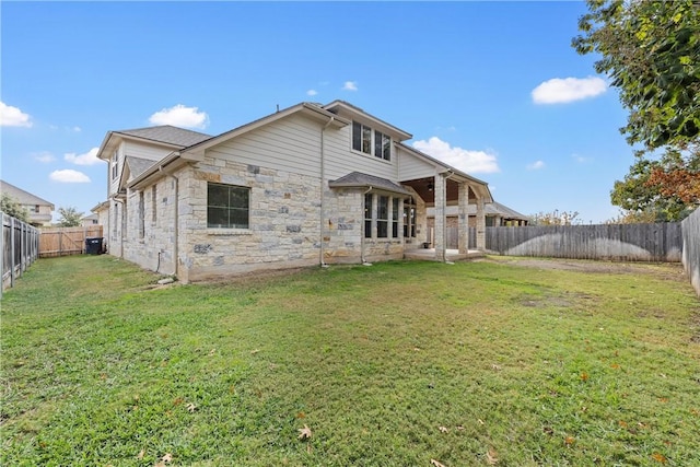 back of house with a lawn