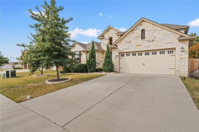 view of front of property featuring a front lawn and a garage