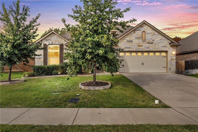 view of front of property featuring a lawn and a garage