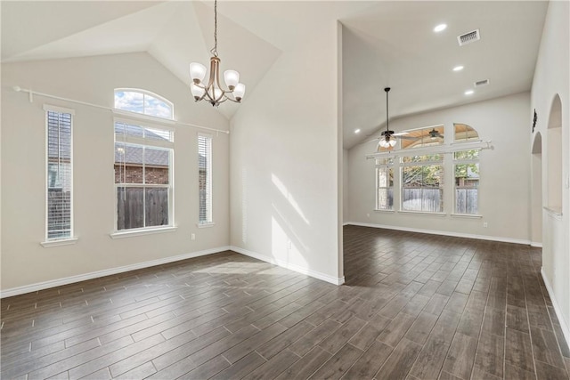 unfurnished room with ceiling fan with notable chandelier, dark wood-type flooring, and vaulted ceiling