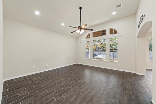 spare room with dark hardwood / wood-style flooring, high vaulted ceiling, and ceiling fan