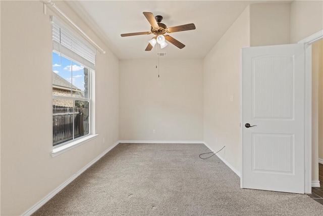 unfurnished room featuring ceiling fan and carpet