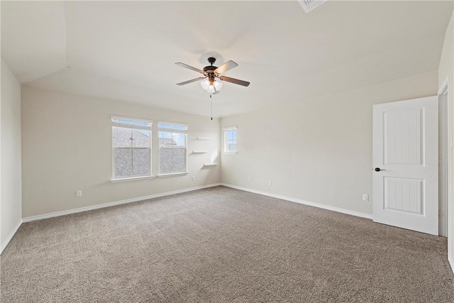 carpeted spare room featuring ceiling fan