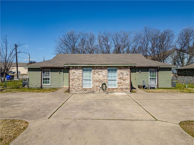 single story home with brick siding and fence