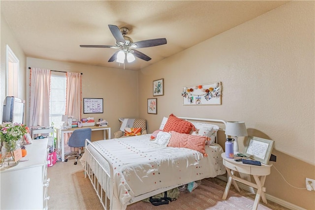 bedroom with ceiling fan and baseboards