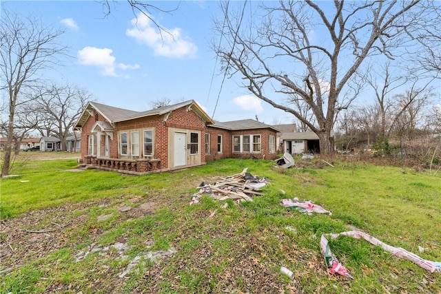 back of property featuring a yard