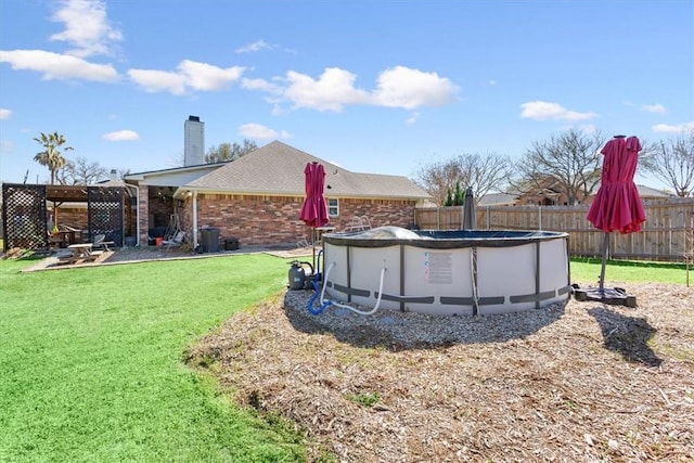 view of yard with a fenced in pool, a pergola, a patio, and fence