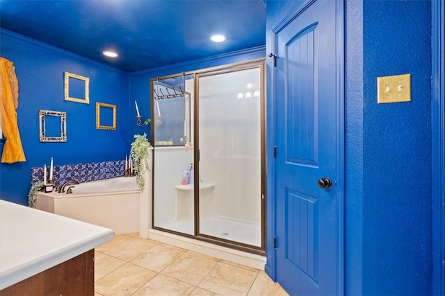 bathroom with a bath, a shower stall, and tile patterned flooring