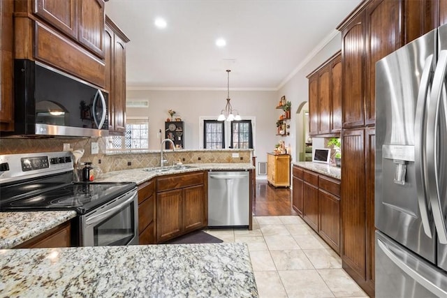 kitchen with light stone countertops, a sink, decorative backsplash, stainless steel appliances, and crown molding