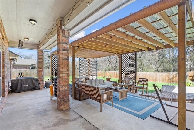 view of patio featuring an outdoor living space, area for grilling, and a fenced backyard