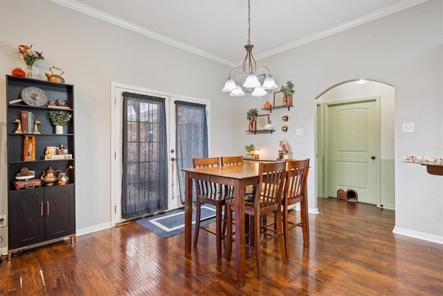 dining room featuring french doors, arched walkways, wood finished floors, and crown molding