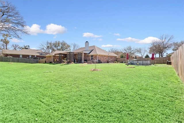 view of yard with a fenced backyard