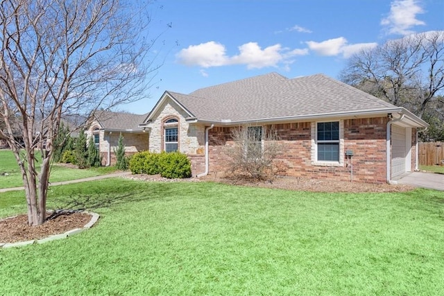 ranch-style house with brick siding, a shingled roof, a front lawn, a garage, and driveway