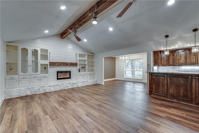 interior space featuring ceiling fan, hardwood / wood-style floors, and lofted ceiling with beams