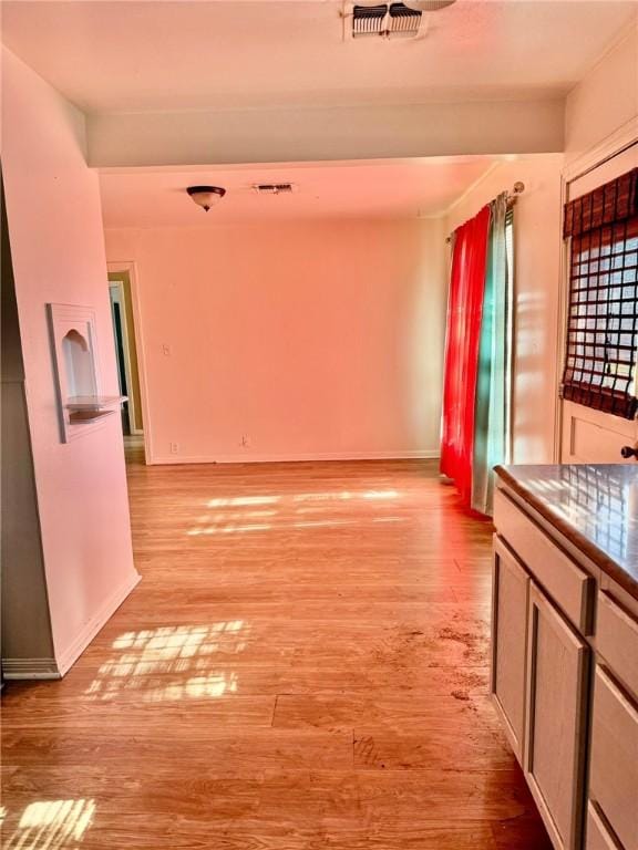 corridor with light hardwood / wood-style flooring