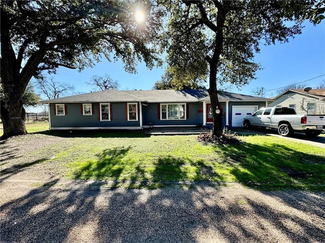 ranch-style home with a front yard and a garage