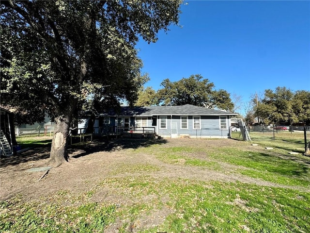 rear view of property featuring a lawn