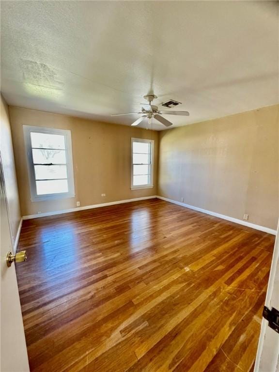 spare room with wood-type flooring and ceiling fan