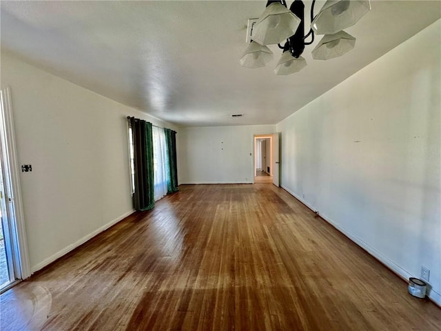 unfurnished room with hardwood / wood-style flooring