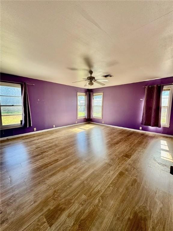 spare room featuring hardwood / wood-style flooring and ceiling fan